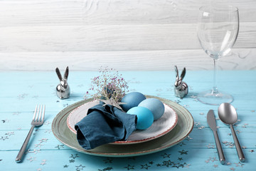 Beautiful Easter table setting on wooden background