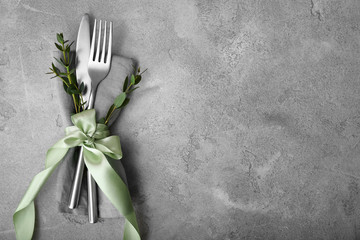 Cutlery for festive table setting on grey background
