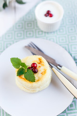 Homemade cheese pancakes on a white plate
