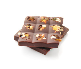 Tasty milk chocolate with candied fruit and nuts on white background
