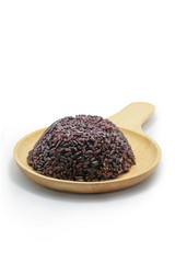 Riceberry Rice On a round wooden plate.on white background.