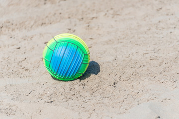 Bright Beach Ball on a Sandy Beach on a Sunny Day