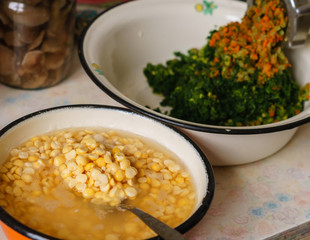 Chopping peas and vegetables in an old meat grinder