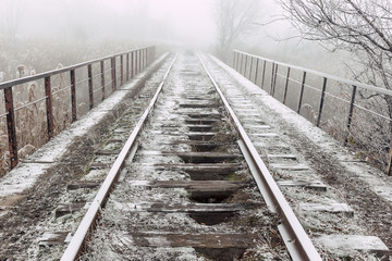 Rails in hoarfrost. Misty autumn morning.