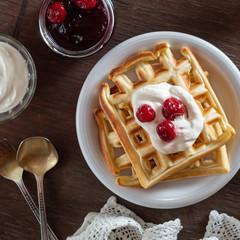 Waffles with sour cream and cherry jam