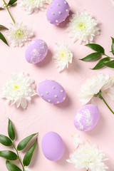 Fototapeta na wymiar Easter eggs with flowers on color background