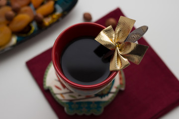 Obraz na płótnie Canvas cup of coffee with red ribbon and bow