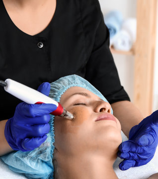 Young woman undergoing procedure of bb glow treatment in beauty salon