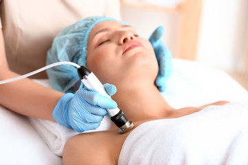 Obraz na płótnie Canvas Young woman undergoing procedure of rf lifting in beauty salon