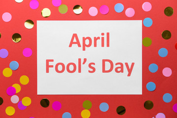 Paper sheet with text APRIL FOOL'S DAY on color background