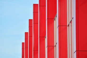 New office building in business center. Wall made of steel and glass with blue sky. 