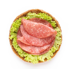 Sandwich with salami sausage on white background.