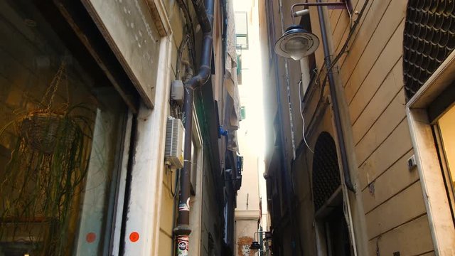 view from below towards the sky in the alleyways, typical narrow streets in the center of Genoa