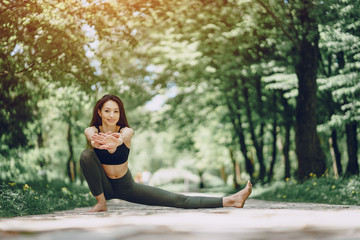 Beautiful and slender girl doing yoga in nature