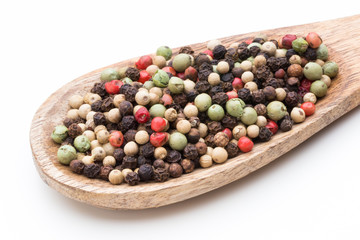 Pepper mix seed on spoon on white background.