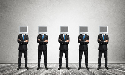 Businessmen with monitors instead of head.