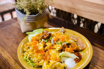 thai style noodle on wooden table and dry flower