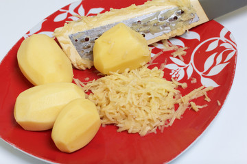 Chopping grated potatoes. Minced meat steaks with potatoes, eggs and cheese. Cooking steps and ingredients.