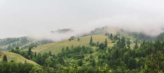 Little house on a green mountain slope