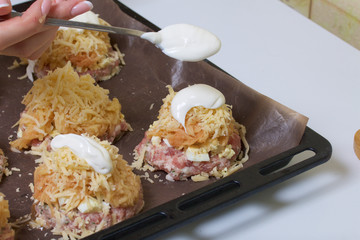 Minced meat steaks with potatoes, eggs and cheese. Cooking steps and ingredients.