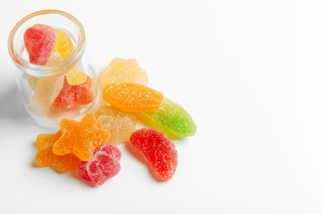 Bottles with sweet candies on table