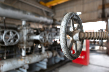 Close-up of industrial metal valve in factory setting