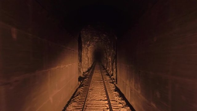 POV of a moving train passing through a narrow tunnel