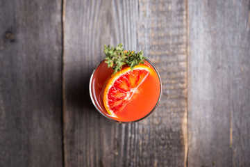 Bloody oranges beverage with thyme. Selective focus. Shallow depth of field.