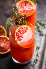 Bloody oranges beverage with thyme. Selective focus. Shallow depth of field.