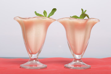 Creamers with sour cream jelly. Decorated with mint leaves.