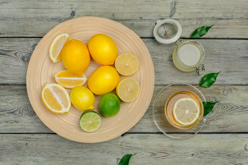 lemon tea with lemon and lime on wooden table