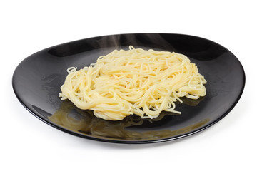 Cooked Spaghetti pasta on black dish on a white background