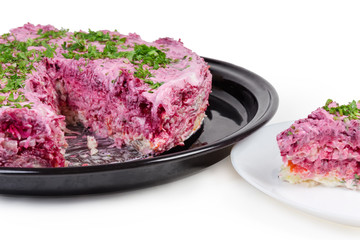 Partly cut so-called dressed herring salad close-up