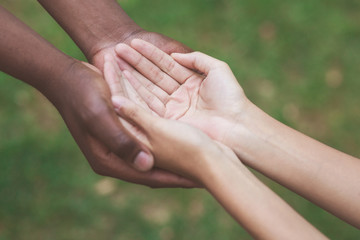 Man and woman hands held together gesturing they need help