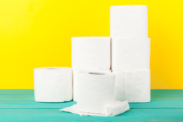 Toilet paper stacks  on bright yellow background