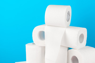 Toilet paper stack on bright blue background