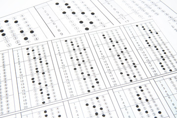 Man is filling OMR sheet handing with pen.