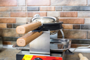 Waffle maker for making Hong Kong waffles in the kitchen of  restaurant
