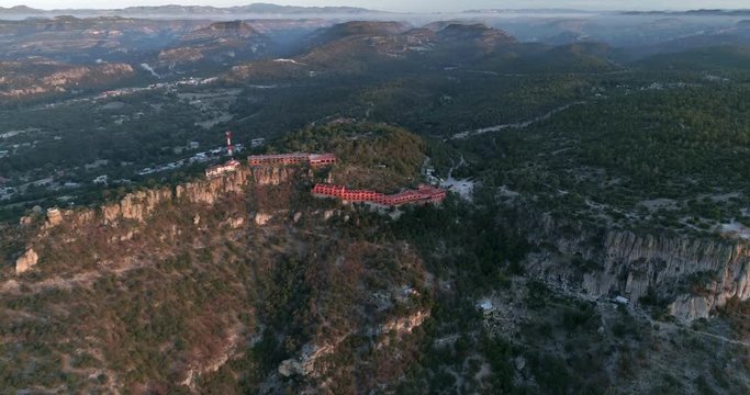 Aerial wide shot a the Urique Canyon and a hotel at sunrise in Divisadero, Copper Canyon Region, Chihuahua.