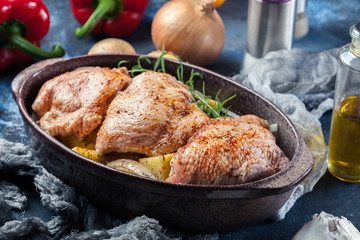 Chicken thighs and potatoes ready for baking