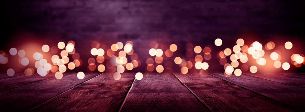 Dark empty stage, multicolored rays of neon searchlight, wet asphalt, smoke, night shooting, bokeh color. 