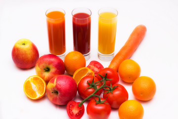 Various vegetable and fruit juices in glass with tomato, carrot, orange and apple  background