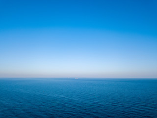 Natural scenery of blue sea or ocean with blue clear sky. Aerial view from drone. Seascape background, copy space.