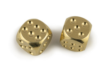 Two golden dices closeup isolated on white background. Six and five, with a shadow.