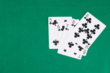 on the green table for poker, there is a black set of cards to win, street, on the left there is a place for the inscription
