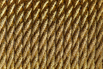 Background texture of gold twisted rope close-up.