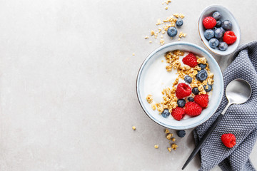 Yogurt with berries and granola in bowl