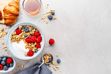 Yogurt with berries and granola in bowl