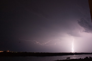 Naklejka na ściany i meble Thunderstorm and lightning over the River at night