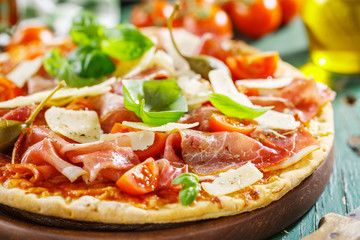 Appetizing italian pizza with prosciutto